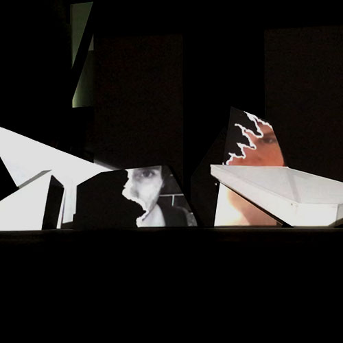 part of the projection mapping showing torn photos of past lovers